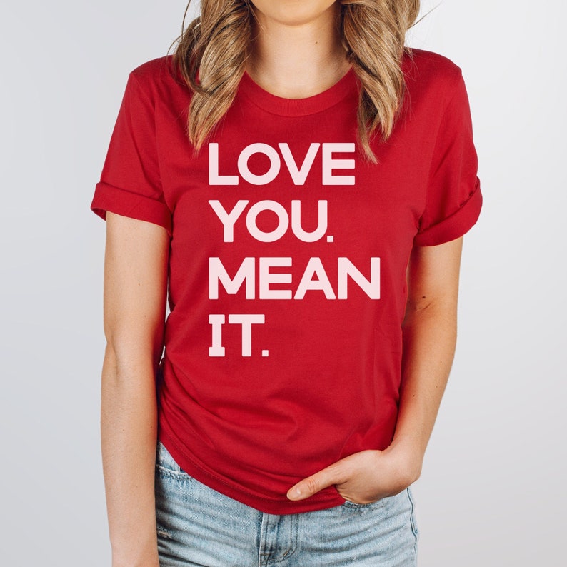 May include: Red t-shirt with white text that reads "LOVE YOU. MEAN IT."