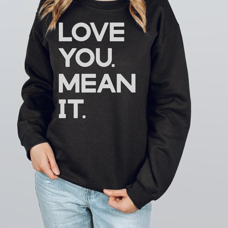 May include: Black sweatshirt with white text that reads "LOVE YOU. MEAN IT."