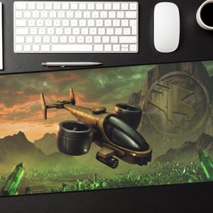May include: A computer mouse pad featuring a futuristic aircraft soaring over a landscape with mountains and glowing green crystals. The aircraft is bronze-colored with black engines and a black cockpit. A logo is visible in the background.