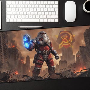 May include: Large rectangular mouse pad featuring a post-apocalyptic scene with a figure in a red and silver suit, holding a glowing blue energy weapon. The background shows a destroyed city with flames and a Soviet emblem.