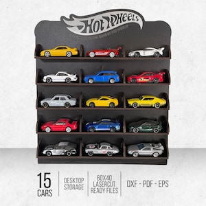 May include: A black wooden Hot Wheels display stand with 15 slots for storing toy cars. The stand is labelled "15 Cars", "Desktop Storage", "60x40 Lasercut Ready Files", and "DXF - PDF - EPS".