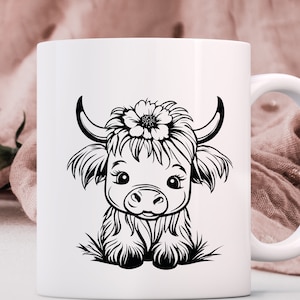 May include: White ceramic mug with a black and white illustration of a Highland cow with a flower on its head.