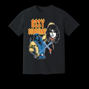 May include: Black t-shirt featuring a graphic of a blue warrior holding an axe and a severed head. The text "OZZY OSBOURNE" is in orange and yellow. The design is a vintage style.
