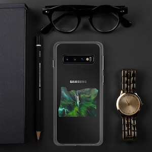 May include: A clear phone case with a green and blue abstract design of the state of Oregon. The case is for a Samsung Galaxy phone and has the Samsung logo on the back.