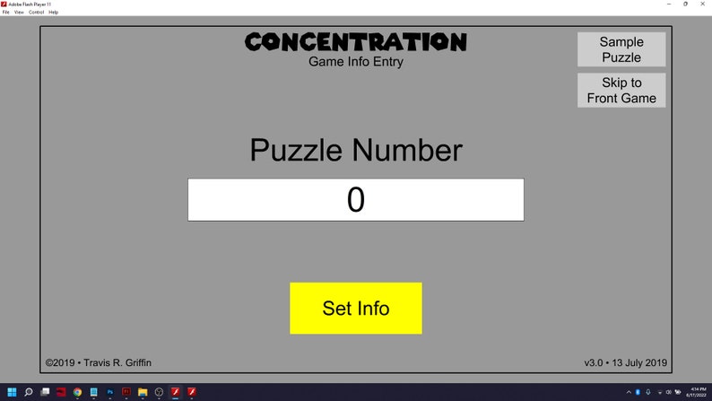 May include: A gray computer screen with a game called 'CONCENTRATION' displayed. The game has a text box labeled 'Puzzle Number' with the number '0' in it. A yellow button labeled 'Set Info' is below the text box. The screen also has two buttons labeled 'Sample Puzzle' and 'Skip to Front Game'.