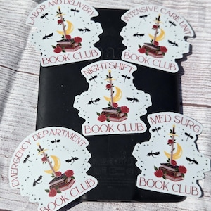 May include: Five white stickers with a unique design featuring a sword, crescent moon, roses, and a stack of books. Each sticker has a different text: "Labor and Delivery Book Club", "Intensive Care Unit Book Club", "Nightshift Book Club", "Emergency Department Book Club", and "Med Surg Book Club".