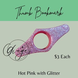 May include: Hot pink thumb bookmark with glitter. The bookmark has a circular opening for the thumb and a flat, angled surface for holding pages open. The text "Thumb Bookmark" is at the top. The text "Hot Pink with Glitter" is at the bottom.