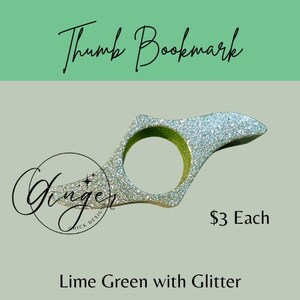 May include: A lime green thumb bookmark with glitter. The bookmark has a ring shape with a pointed end. The text "Thumb Bookmark" is at the top, and "Lime Green with Glitter" is at the bottom.