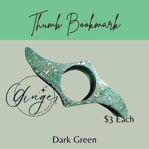May include: Dark green thumb bookmark with glitter accents. The bookmark has a circular opening for the thumb and two pointed ends. The text "Thumb Bookmark" is at the top. The text "Ginger Chick Designs" is in a circle.
