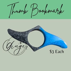 May include: A thumb bookmark with a black and silver glitter design on one side and a blue design on the other. The text "Thumb Bookmark" is at the top, and the text "Ginger Quick Designs" is at the bottom.