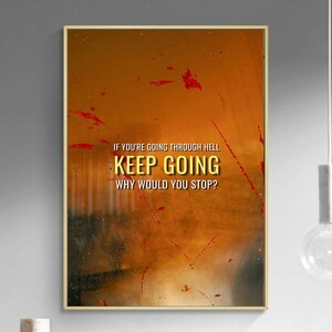 May include: A motivational poster with a yellow background and red splatters of paint. The text reads "If you're going through hell, keep going. Why would you stop?"