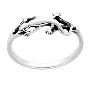 May include: A silver ring featuring a lizard design. The lizard is depicted in a running pose and has textured scales.