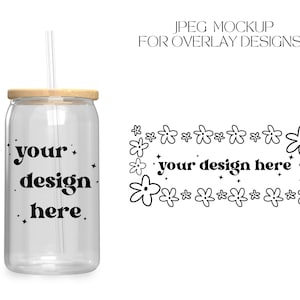 May include: A clear glass tumbler with a wooden lid and a straw. The tumbler has the text "your design here" printed on it. The tumbler is surrounded by a border of small black flowers.