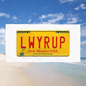 Puede incluir: Una placa de matrícula amarilla y azul de Nuevo México con el texto "LWYRUP" en letras rojas. La placa también dice "Nuevo México USA" y "Tierra de Encanto".