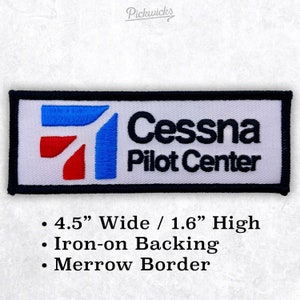 May include: White embroidered patch with a blue and red airplane logo and the text "Cessna Pilot Center". The patch is 4.5 inches wide and 1.6 inches high. It has an iron-on backing and a merrow border.
