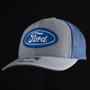 May include: A gray and blue trucker hat with a blue oval patch that says "Ford" in white lettering.