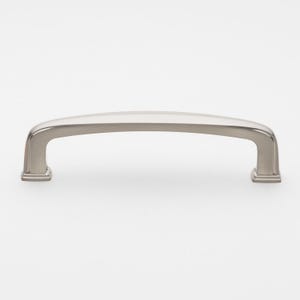 May include: A brushed nickel cabinet pull with a slightly curved shape and squared ends.