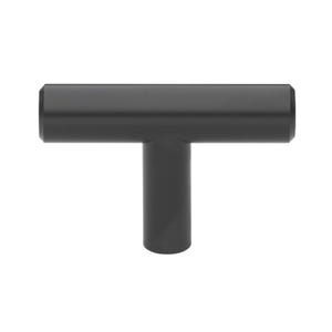 May include: A matte black T-shaped cabinet pull. The hardware features a cylindrical vertical post and a horizontal bar, creating a minimalist design. The pull is designed for easy gripping and opening of drawers or cabinets.