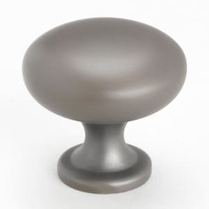 May include: A round, gray cabinet knob with a smooth, slightly domed top and a short, cylindrical base.