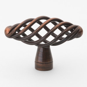May include: A bronze cabinet knob with a twisted, cage-like design. The knob has a round base.