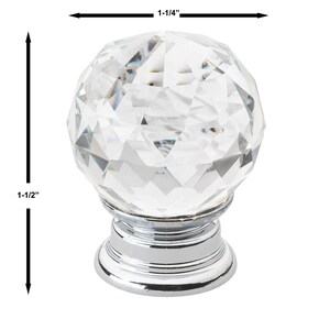 May include: A clear crystal cabinet knob with a faceted design and a chrome base. The knob measures 1-1/4 inches in diameter and 1-1/2 inches in height.
