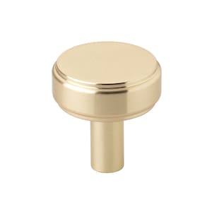 May include: A gold-toned cabinet knob with a round, fluted top and a cylindrical base.