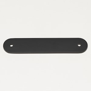 May include: A black metal rectangular sign with rounded edges and two holes for hanging.