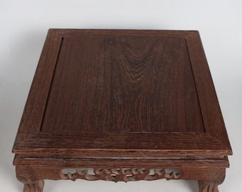 Small wooden table with hand-carved chicken wings