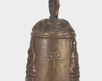 Folk collection of hand-carved brass bell statue