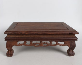 Small wooden table with hand-carved chicken wings