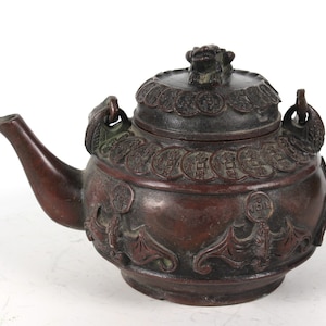 Hand-carved copper teapots from folk collections