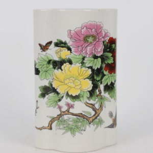 A folk collection of hand-painted ceramic pen holders