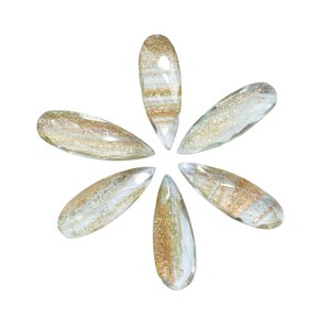 May include: Six clear glass teardrop-shaped ornaments with gold and white glitter accents arranged in a starburst pattern.