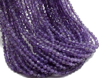 May include: Strands of faceted amethyst beads in varying shades of purple. The beads are small and round, with a sparkling, polished finish. The strands are draped against a white background.