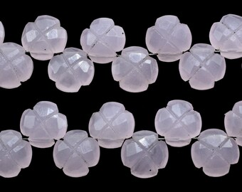 May include: A strand of pale pink gemstone beads, each bead is carved in the shape of a four-leaf clover.