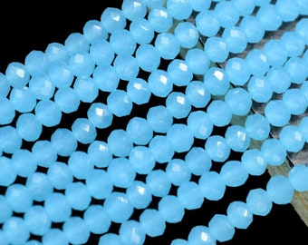 May include: A strand of light blue faceted gemstone beads. The beads are small and round, and they are strung together on a clear thread.