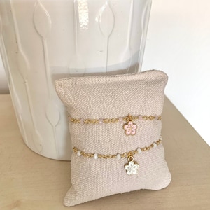 Gold and pink beaded chain bracelet with hibiscus flower enamel charm