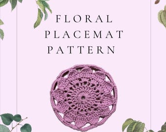 May include: A crochet pattern for a floral placemat, featuring a pink crocheted placemat with a floral design. The pattern is by Carpe Crochet Studios.