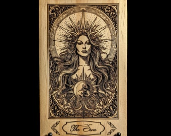 May include: A wooden plaque with a laser-engraved image of a woman with long hair and a crown of stars. The image is surrounded by an ornate frame and the text "The Sun" is below the image.