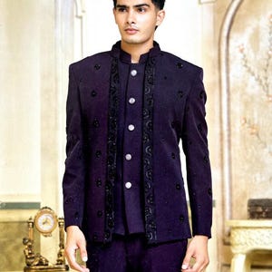 May include: A dark purple suit with a mandarin collar, featuring decorative black embroidery and silver buttons. The suit includes a jacket and matching pants, suitable for formal occasions.