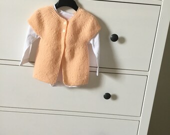 Small wool bra with short sleeves pale orange knitted in 3 months for baby