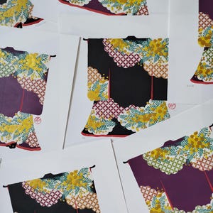 May include: Multiple art prints featuring a stylized kimono illustration. The kimono is depicted in black or deep purple with a vibrant pattern of yellow mimosa flowers, green fern-like leaves, and a geometric white and red circular motif.