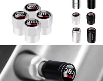 May include: A collection of silver and black tire valve caps with the Audi logo in red. The caps are shown in various styles, including silver, black, and a silver cap with the word "sports" printed on it. The text "Tire valve" is at the top.