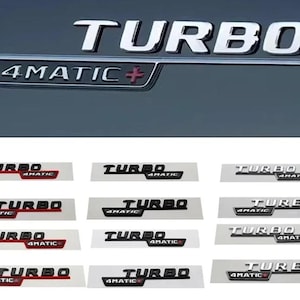 May include: Chrome "TURBO" and "4MATIC+" car emblems. The image shows several variations of the emblems, with different color schemes, including black, red, and silver. The emblems are displayed on a gray background.