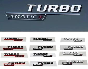 May include: Chrome "TURBO" and "4MATIC+" car emblems. The image shows several variations of the emblems, with different color schemes, including black, red, and silver. The emblems are displayed on a gray background.