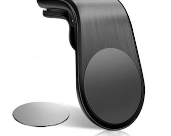 May include: A black car phone mount with a brushed metal finish. The mount has a circular magnetic area and a separate silver magnetic disc. The mount is designed to attach to a car's air vent.