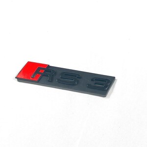 May include: Black and red "RS 3" emblem. The "R" is red and the "S 3" are black.