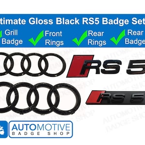 May include: Gloss black Audi RS5 badge set. Includes a grill badge, front and rear rings, and a rear badge. The badges have a red accent.