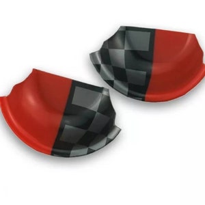 May include: Two red and black chequered car door handle covers. The covers are made of a flexible plastic material and are designed to fit over the existing door handles.