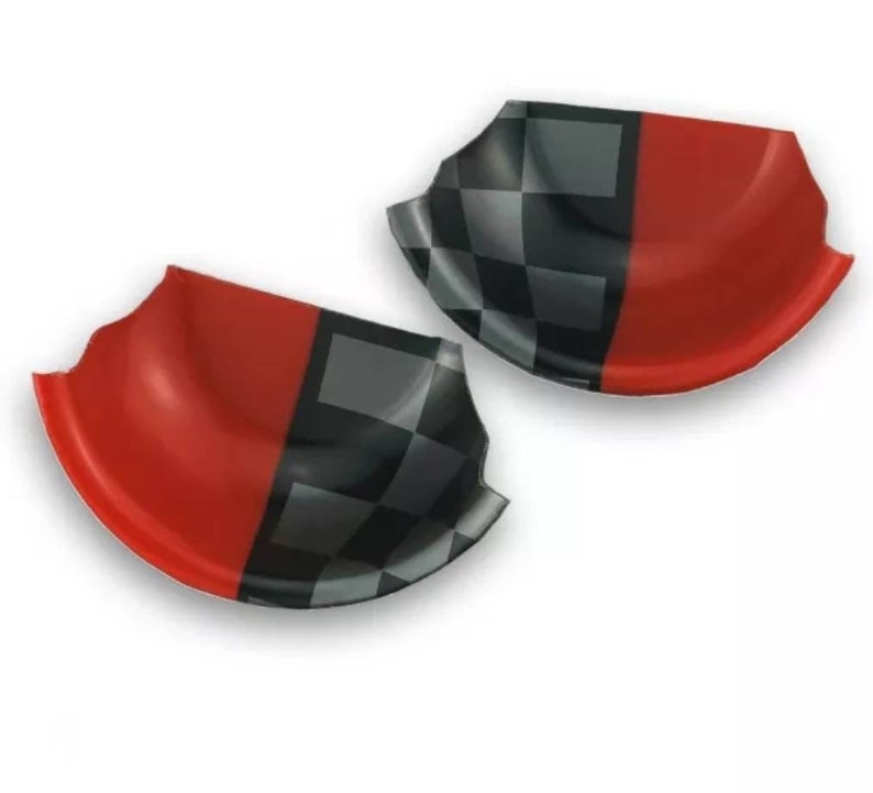May include: Two red and black chequered car door handle covers. The covers are made of a flexible plastic material and are designed to fit over the existing door handles.